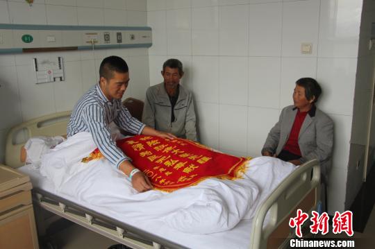 被救的李忠起、張總鳳夫婦看望受傷后的李運(yùn)飛。　汪渝 攝